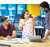 Three colleagues in an office workspace discussing material spread across a table in front of them, with one person seated and the other two people standing and engaging in discussion. 